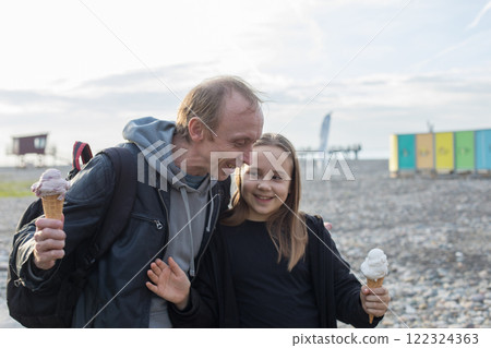 Carefree family. Cute child and father walking and enjoying ice cream at sunny day. Carefree family. Cute child and father walking and enjoying ice cream at sunny day. 122324363
