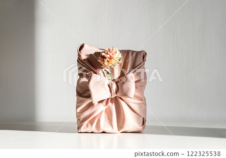 Present wrapped with furoshiki fabric. Present wrapped with furoshiki fabric. 122325538