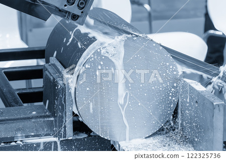 The band saw cutting machine cutting the metal shaft parts with coolant method. The band saw cutting machine cutting the metal shaft parts with coolant method. 122325736