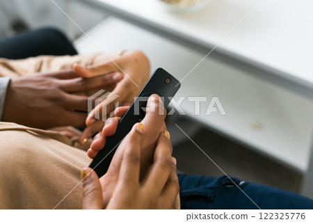 Remote control is pointed toward the television screen, control and choice of tv entertainment. TV, series and streaming service concept 122325776