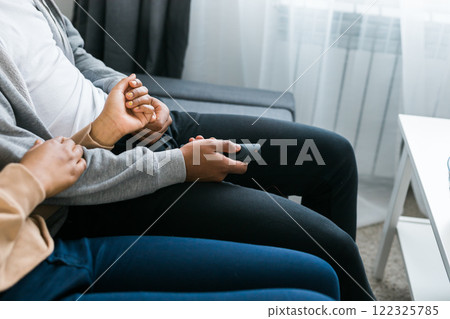 Remote control is pointed toward the television screen, control and choice of tv entertainment. TV, series and streaming service concept Remote control is pointed toward the television screen, control and choice of tv entertainment. TV, series and streaming service concept 122325785
