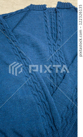 Knitted product from blue threads. Ready-made handmade women's sweater. Knitted product from blue threads. Ready-made handmade women's sweater. 122326135