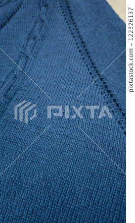 Knitted product from blue threads. Ready-made handmade women's sweater. Knitted product from blue threads. Ready-made handmade women's sweater. 122326137