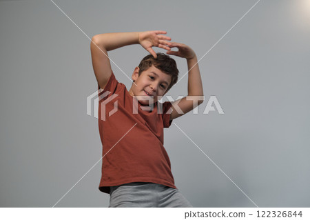 Cheerful and hands up, he exudes playfulness. Highlights the need for play in learning. 122326844