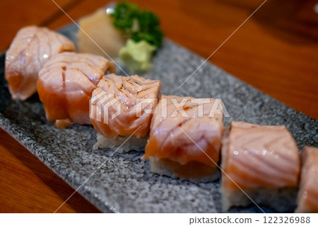 Burned Salmon Sushi roll served on plate Burned Salmon Sushi roll served on plate 122326988