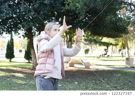 Active playing child girl outdoors portrait 122327197