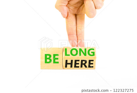Belonging and belong symbol. Concept words Be here Belong on beautiful wooden block. Beautiful white background Businessman hand. Business motivational belonging and belong concept. Copy space. 122327275