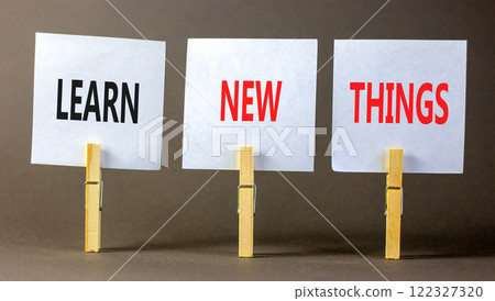 Learn new things symbol. Concept words Learn new things on beautiful white paper on clothespin. Beautiful grey background. Business motivational learn new things concept. Copy space. Learn new things symbol. Concept words Learn new things on beautiful white paper on clothespin. Beautiful grey background. Business motivational learn new things concept. Copy space. 122327320
