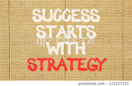 Success starts with strategy symbol. Concept words Success starts with strategy on beautiful brick wall. Beautiful brick wall background. Business and success starts with strategy concept. Copy space. Success starts with strategy symbol. Concept words Success starts with strategy on beautiful brick wall. Beautiful brick wall background. Business and success starts with strategy concept. Copy space. 122327335