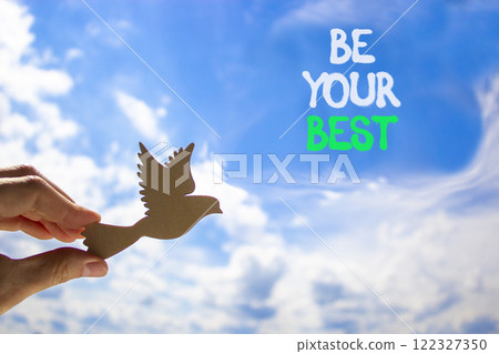 Motivational be your best symbol. Concept words Be your best on beautiful blue sky. Beautiful blue sky and clouds background. Businessman hand. Business motivational be your best concept. Copy space. Motivational be your best symbol. Concept words Be your best on beautiful blue sky. Beautiful blue sky and clouds background. Businessman hand. Business motivational be your best concept. Copy space. 122327350