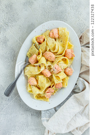 papardelle pasta, in creamy sauce with salmon, homemade, on a gray background, no people, papardelle pasta, in creamy sauce with salmon, homemade, on a gray background, no people, 122327438