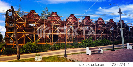The historic building of 1914, Gostiny Dvor, is surrounded by wooden forests and overgrown plants. Kimry city, Tver region, 06/07/2023 mobile photo, no people 122327465