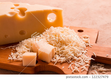 Grated cheese, Maasdam, on a cutting board, grater and cheese knife, close-up, no people, 122327479
