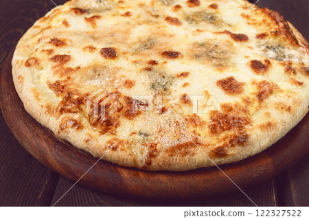 Freshly baked cheese pizza, with a golden crust and bubbling melted cheese, white pizza, on a wooden board, homemade, no people, 122327522