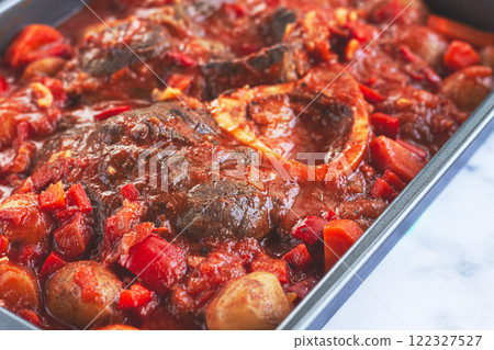 ossobuco stew with vegetables, knuckle on the bone with new potatoes, in tomato sauce,homemade, top view, no people, 122327527