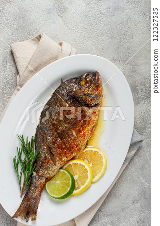 baked dorado fish, in the oven, fried dorado, with spices and herbs, on a white plate, top view, homemade, no people, baked dorado fish, in the oven, fried dorado, with spices and herbs, on a white plate, top view, homemade, no people, 122327585