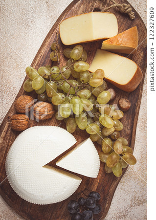 Georgian cheese, Imeretian and smoked suluguni, grapes, nuts, on a cutting board, Georgian cuisine, no people, 122327609