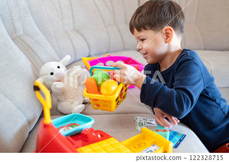 A child plays grocery store with a stuffed toy. 122328715