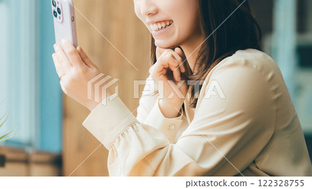 Smiling woman/businesswoman using a smartphone Smiling woman/businesswoman using a smartphone 122328755