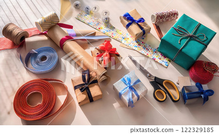 Creative workspace filled with colorful materials for making handmade festive gifts, including ribbons, wrapping paper, and scissors, perfect for holiday crafting 122329185