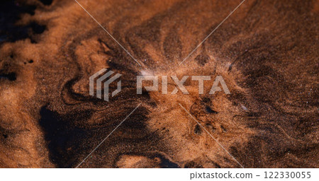 Art magma. Shimmering explosion. Orange paint lava eruption volcano. Molten copper mass spread mix across black liquid abstract background. 122330055