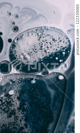 Art liquid. Bubble emulsion. Splatter pigment particles floating in grunge water. Gray black blue ink drop bursting mix blur abstract background. Art liquid. Bubble emulsion. Splatter pigment particles floating in grunge water. Gray black blue ink drop bursting mix blur abstract background. 122330060