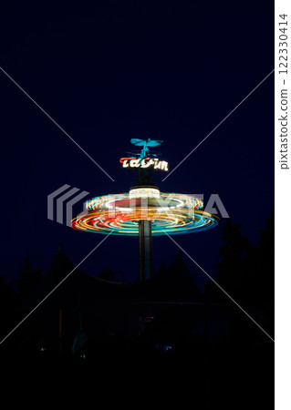Kouvola, Finland - 26 August 2023: Rotating ride Taifun in amusement park Tykkimaki at night 122330414