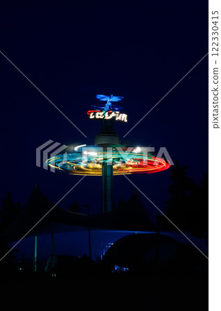 Kouvola, Finland - 26 August 2023: Rotating ride Taifun in amusement park Tykkimaki at night 122330415