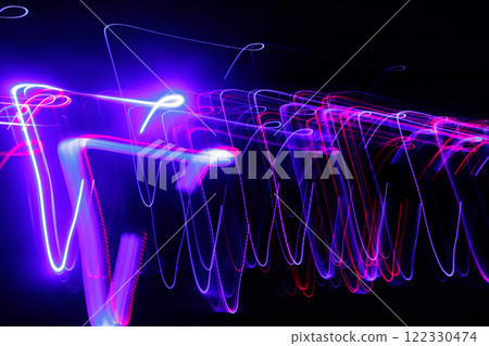 Abstract blurred colorful light effect on a black background. Long exposure photo of moving camera. 122330474