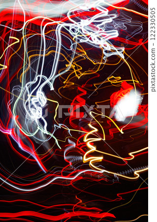 Abstract blurred colorful light effect on a black background. Long exposure photo of moving camera. Abstract blurred colorful light effect on a black background. Long exposure photo of moving camera. 122330505
