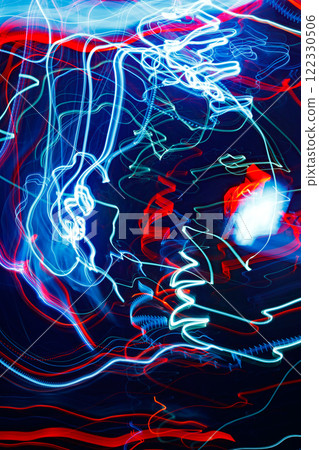 Abstract blurred colorful light effect on a black background. Long exposure photo of moving camera. Abstract blurred colorful light effect on a black background. Long exposure photo of moving camera. 122330506
