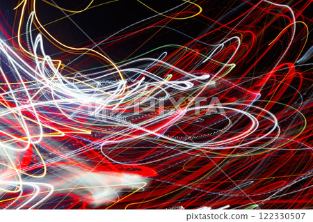 Abstract blurred colorful light effect on a black background. Long exposure photo of moving camera. Abstract blurred colorful light effect on a black background. Long exposure photo of moving camera. 122330507