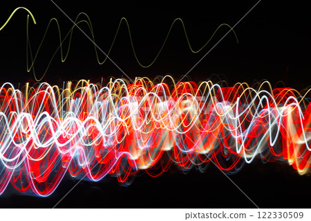 Abstract blurred colorful light effect on a black background. Long exposure photo of moving camera. 122330509