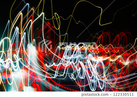 Abstract blurred colorful light effect on a black background. Long exposure photo of moving camera. 122330511