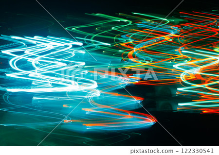 Abstract blurred colorful light effect on a black background. Long exposure photo of moving camera. 122330541