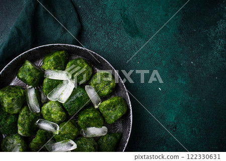 Frozen spinach green cubes in bowl 122330631