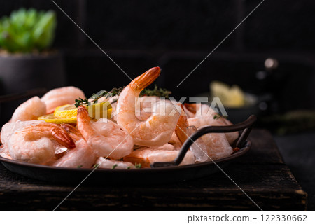 Frozen uncooked prawns or shrimps with lemon 122330662