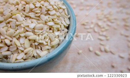 Split Dehusked Black Gram White Lentils in a Blue Bowl, Closeup Split Dehusked Black Gram White Lentils in a Blue Bowl, Closeup 122330923