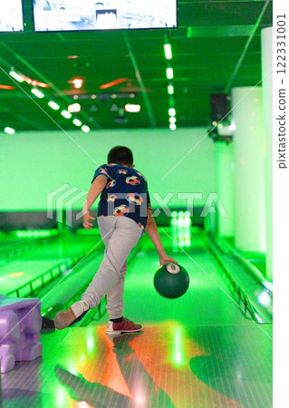 Young boy child having fun and playing bowling Young boy child having fun and playing bowling 122331001