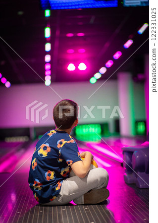 happy young boy child have fun cheering while playing bowling game bowling alley 122331025
