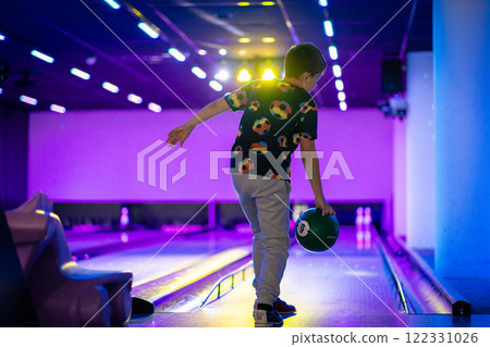 happy young boy child have fun cheering while playing bowling game bowling alley 122331026