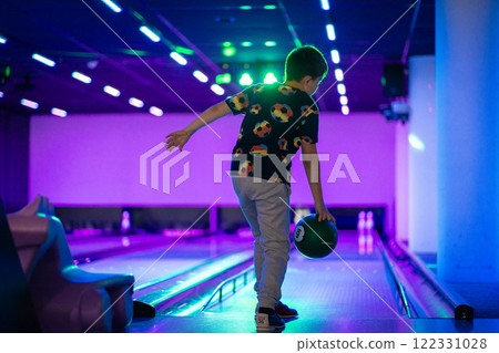 happy young boy child have fun cheering while playing bowling game bowling alley happy young boy child have fun cheering while playing bowling game bowling alley 122331028