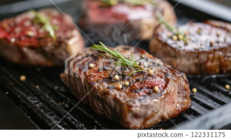 Herb infused steaks grilling outside 122331175