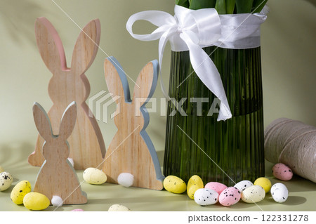 Happy EASTER composition wooden bunny eggs Fresh bouquet of colorful tulip flowers in pastel background with shadows. Minimalist design greeting card for springtime holidays. Gift for Easter. Happy EASTER composition wooden bunny eggs Fresh bouquet of colorful tulip flowers in pastel background with shadows. Minimalist design greeting card for springtime holidays. Gift for Easter. 122331278