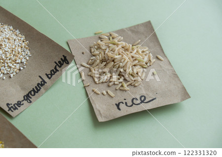 Refillable raw brown rice porridge with text in paper examples. Refill product format eco-friendly living. Whole spelt grain species. High protein fiber-rich vegan plant based food ingredient. Gluten Refillable raw brown rice porridge with text in paper examples. Refill product format eco-friendly living. Whole spelt grain species. High protein fiber-rich vegan plant based food ingredient. Gluten 122331320