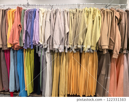 Colorful display of cozy sweatshirts hanging in a trendy clothing store 122331383