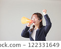Woman cheering with megaphone in hand_1 122331649
