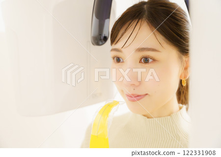 Young woman taking a dental x-ray Young woman taking a dental x-ray 122331908