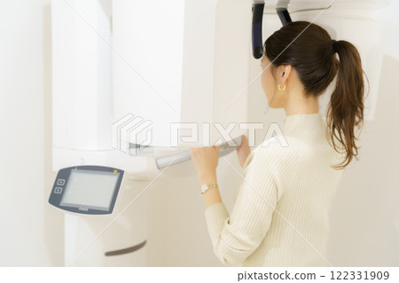 Young woman taking a dental x-ray 122331909