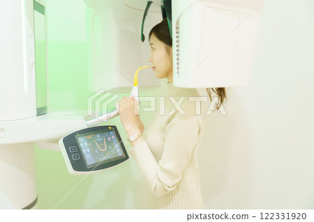 Young woman taking a dental x-ray Young woman taking a dental x-ray 122331920